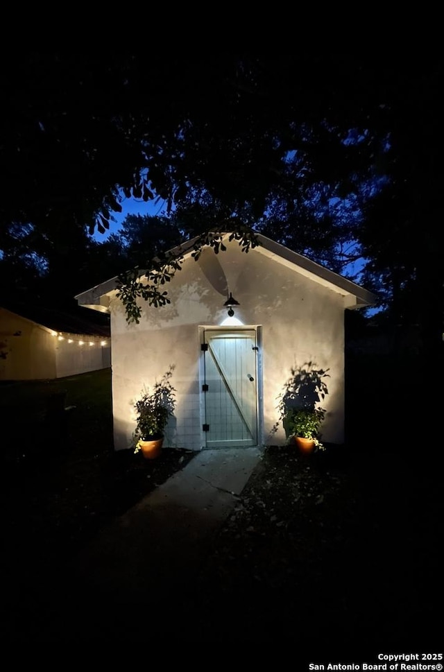 view of exterior entry at twilight