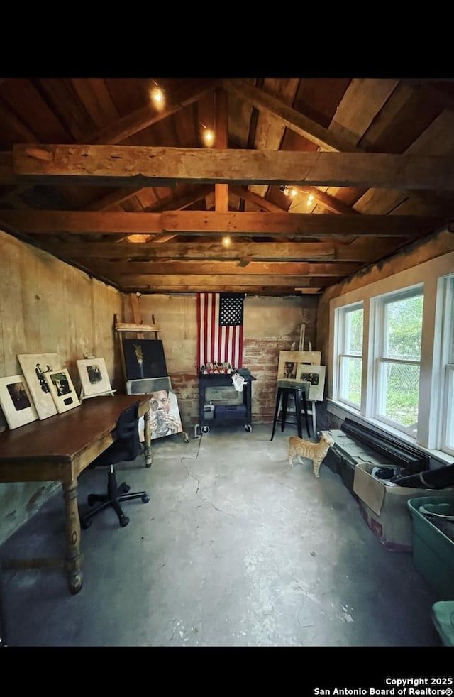 miscellaneous room with vaulted ceiling with beams, concrete floors, and wooden ceiling