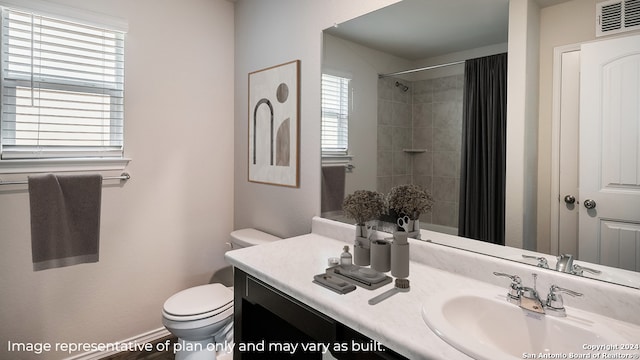 bathroom with curtained shower, vanity, and toilet