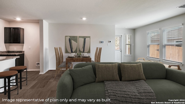 living room featuring dark hardwood / wood-style flooring and a textured ceiling