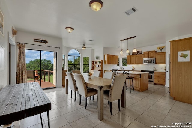 dining space featuring light tile patterned floors and ceiling fan