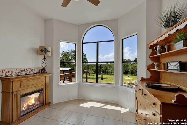 unfurnished room featuring ceiling fan and light tile patterned flooring