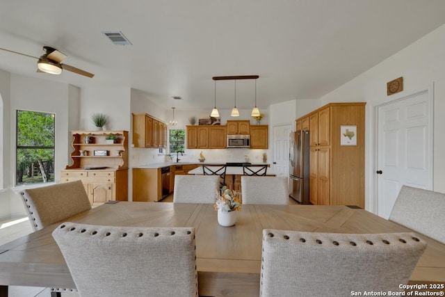 dining space with ceiling fan, sink, and a healthy amount of sunlight