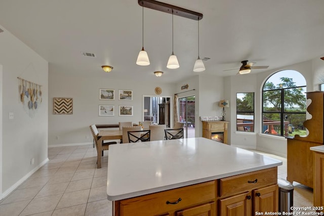 kitchen with pendant lighting, ceiling fan, and light tile patterned flooring