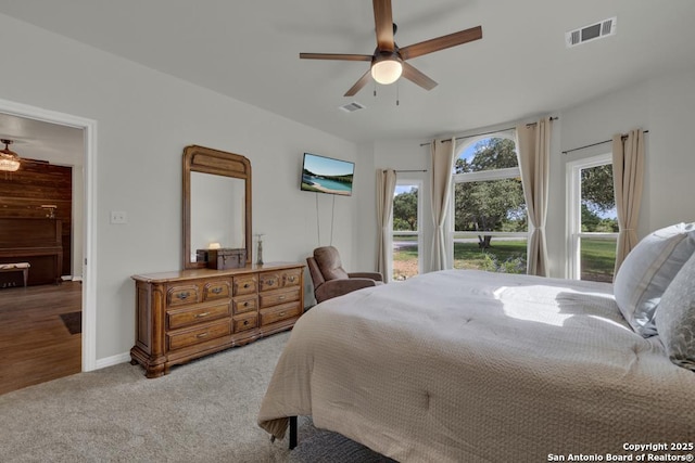 bedroom featuring ceiling fan and light colored carpet