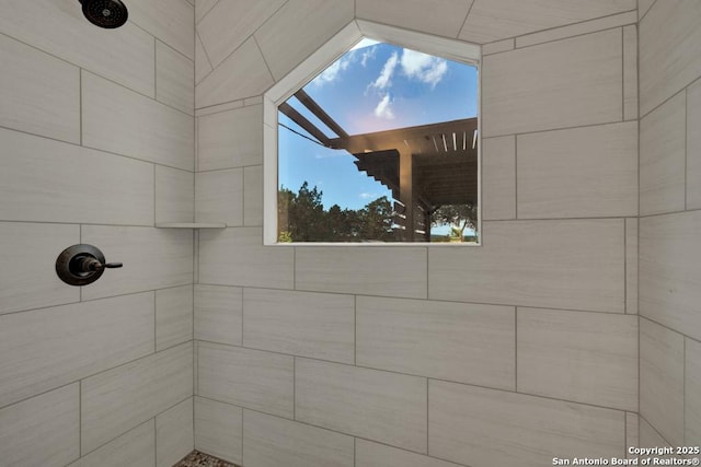 bathroom with a tile shower