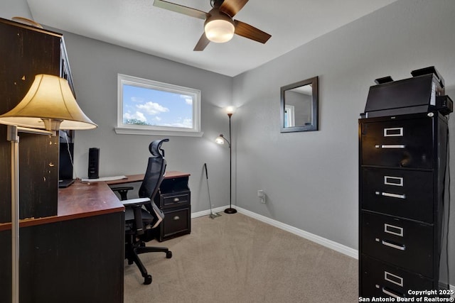 home office with light carpet and ceiling fan