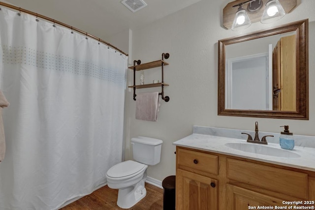 bathroom featuring hardwood / wood-style floors, vanity, a shower with shower curtain, and toilet