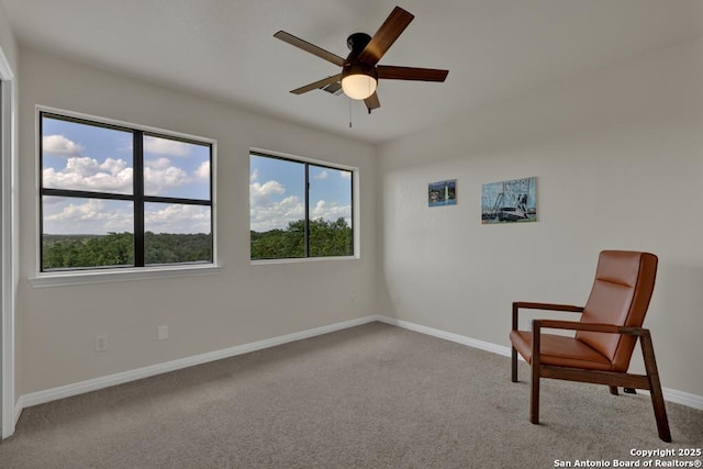 unfurnished room with ceiling fan and light carpet