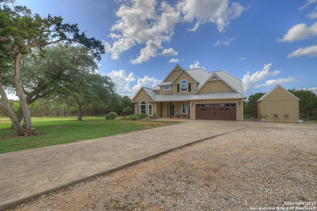 view of front of home featuring a front yard, a garage, and covered porch