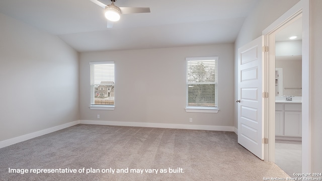 unfurnished room with ceiling fan, sink, light carpet, and vaulted ceiling