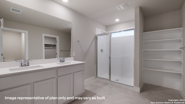 bathroom featuring vanity and a shower with door