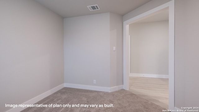empty room with light colored carpet