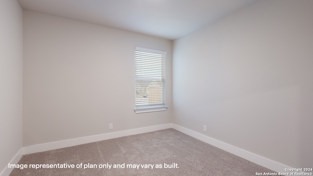 empty room featuring light colored carpet