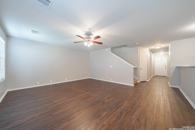 unfurnished room featuring ceiling fan and dark wood-type flooring