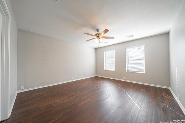 unfurnished room featuring dark hardwood / wood-style floors and ceiling fan