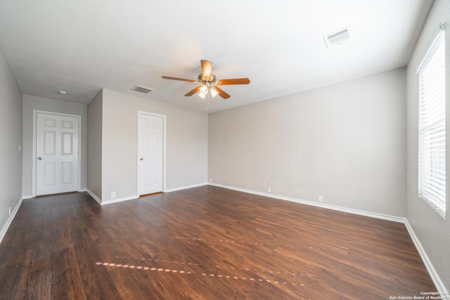 spare room featuring ceiling fan and dark hardwood / wood-style flooring