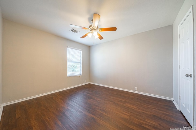 empty room featuring ceiling fan and dark wood-type flooring