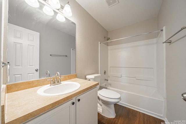 full bathroom featuring shower / tub combination, hardwood / wood-style floors, vanity, and toilet