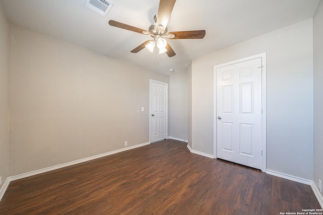 unfurnished bedroom with ceiling fan and dark wood-type flooring