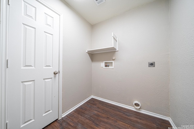 clothes washing area with dark hardwood / wood-style flooring, washer hookup, and hookup for an electric dryer