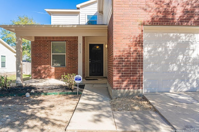 entrance to property with covered porch and a garage