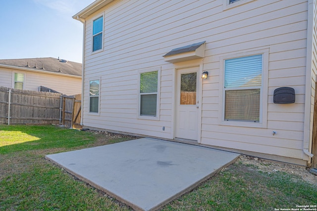 property entrance featuring a yard and a patio