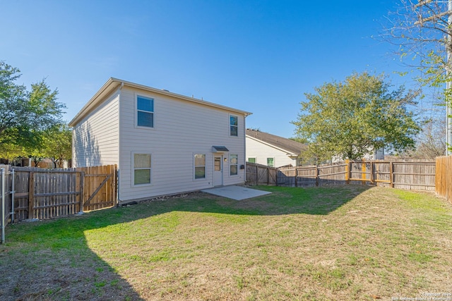 rear view of house with a lawn and a patio area