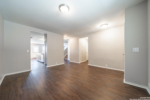 empty room with dark hardwood / wood-style flooring