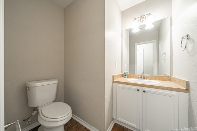 bathroom featuring vanity, toilet, and wood-type flooring