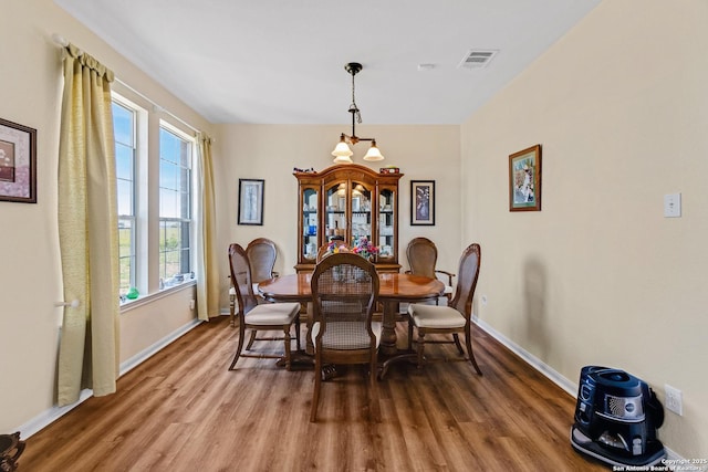 dining space with hardwood / wood-style floors