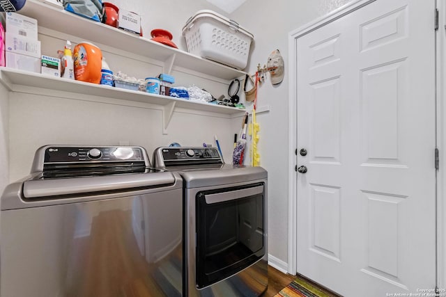 laundry area featuring independent washer and dryer and dark wood-type flooring