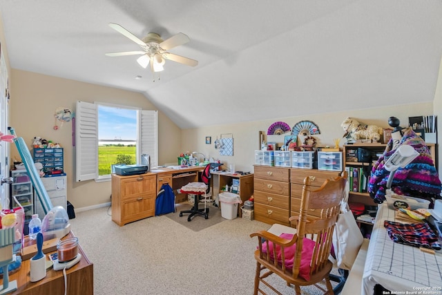 carpeted office space with ceiling fan and lofted ceiling