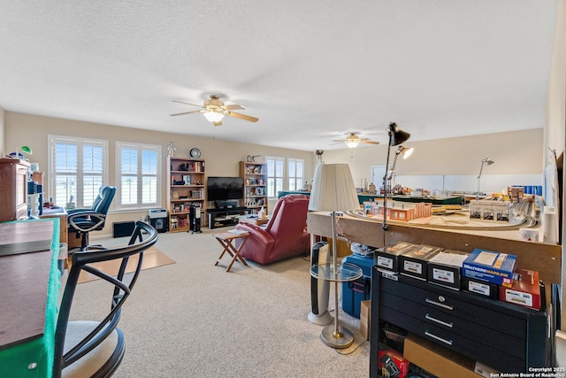 interior space with ceiling fan, carpet, and a textured ceiling