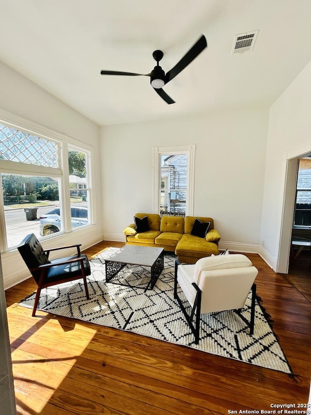 living room with ceiling fan and hardwood / wood-style floors