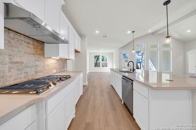 kitchen with a center island with sink, stainless steel appliances, light countertops, under cabinet range hood, and a sink