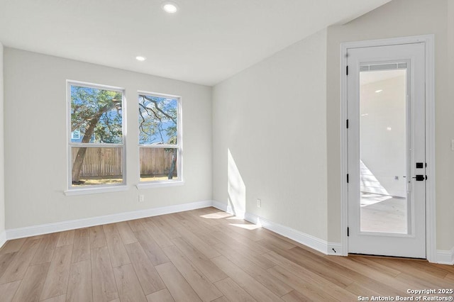 unfurnished room with recessed lighting, baseboards, and light wood finished floors