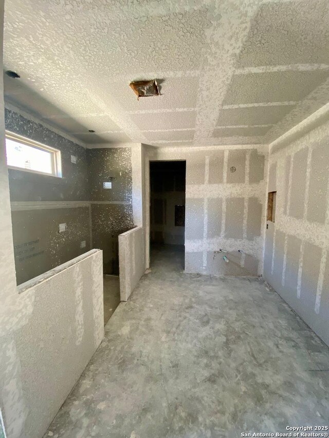 unfurnished room featuring a textured ceiling