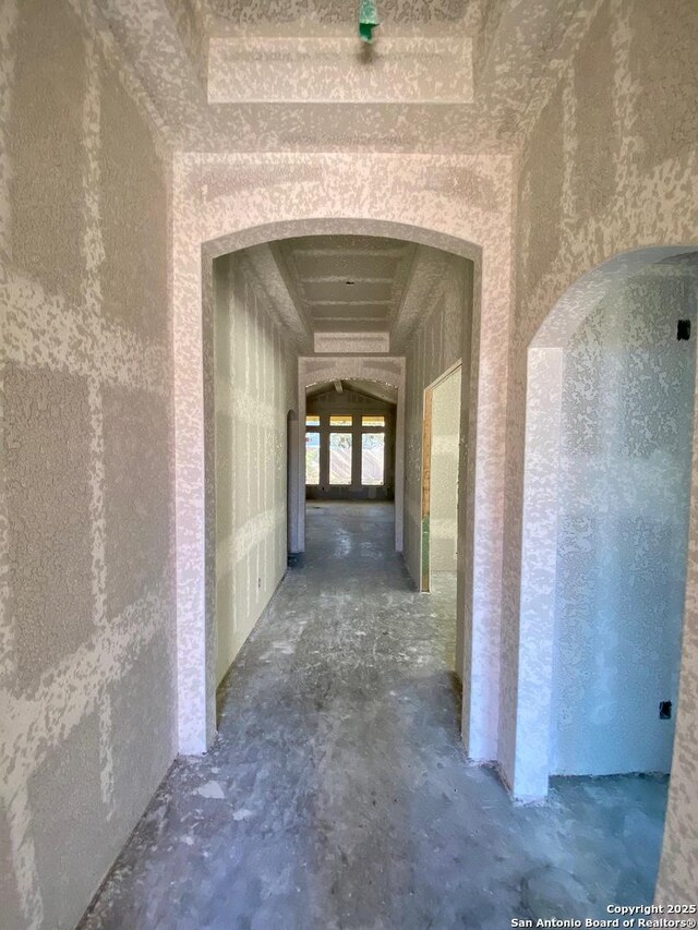 hall featuring unfinished concrete floors