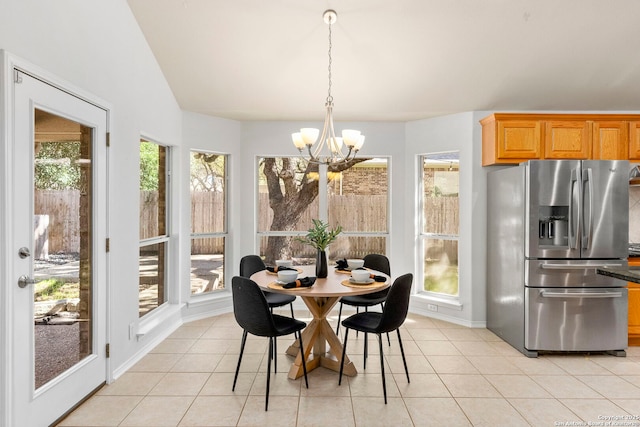 tiled dining area with a notable chandelier