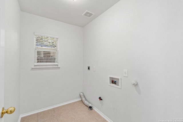 washroom with washer hookup, hookup for a gas dryer, hookup for an electric dryer, and light tile patterned floors