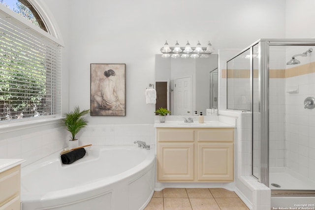 bathroom with shower with separate bathtub, vanity, tile patterned floors, and a healthy amount of sunlight