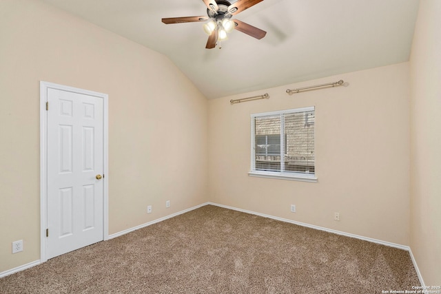 carpeted empty room featuring ceiling fan and vaulted ceiling