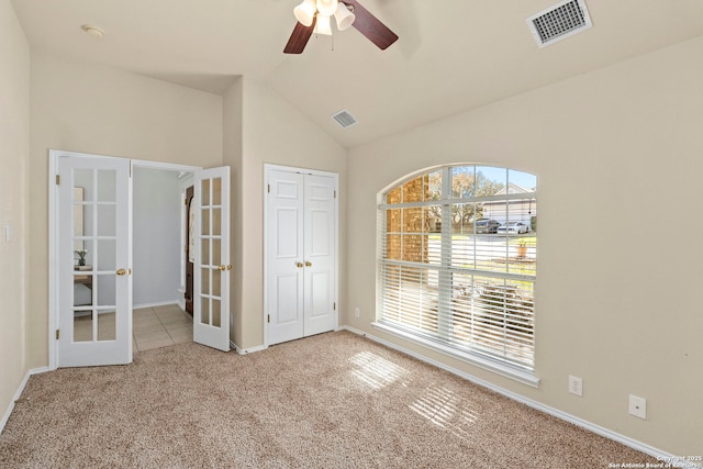 interior space featuring ceiling fan, lofted ceiling, and french doors