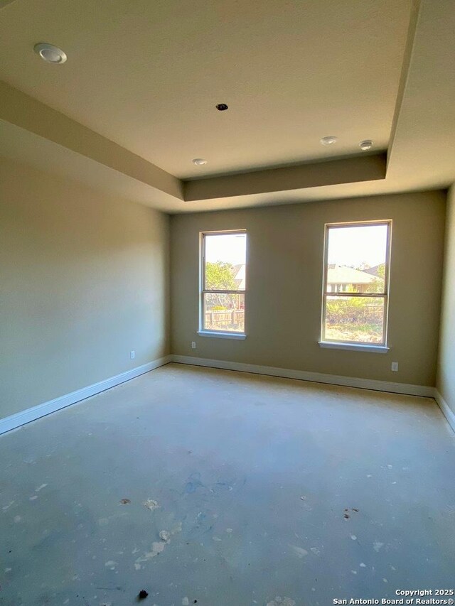 empty room with a raised ceiling