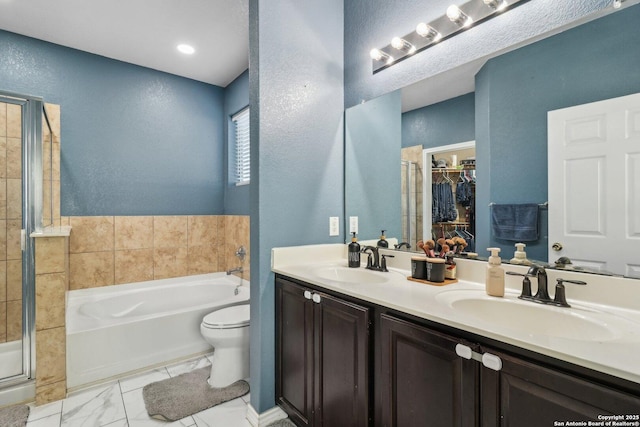 full bathroom featuring vanity, separate shower and tub, and toilet