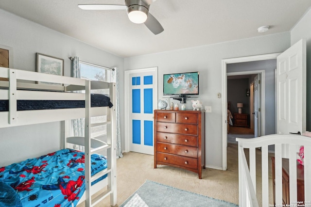 carpeted bedroom with ceiling fan