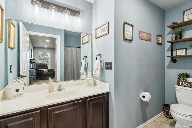 bathroom with tile patterned floors, vanity, and toilet