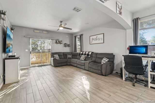 living room featuring ceiling fan and light hardwood / wood-style floors