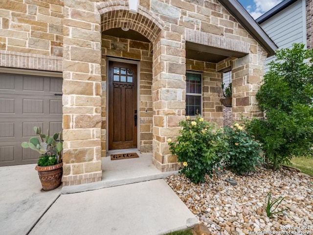 view of exterior entry featuring a garage